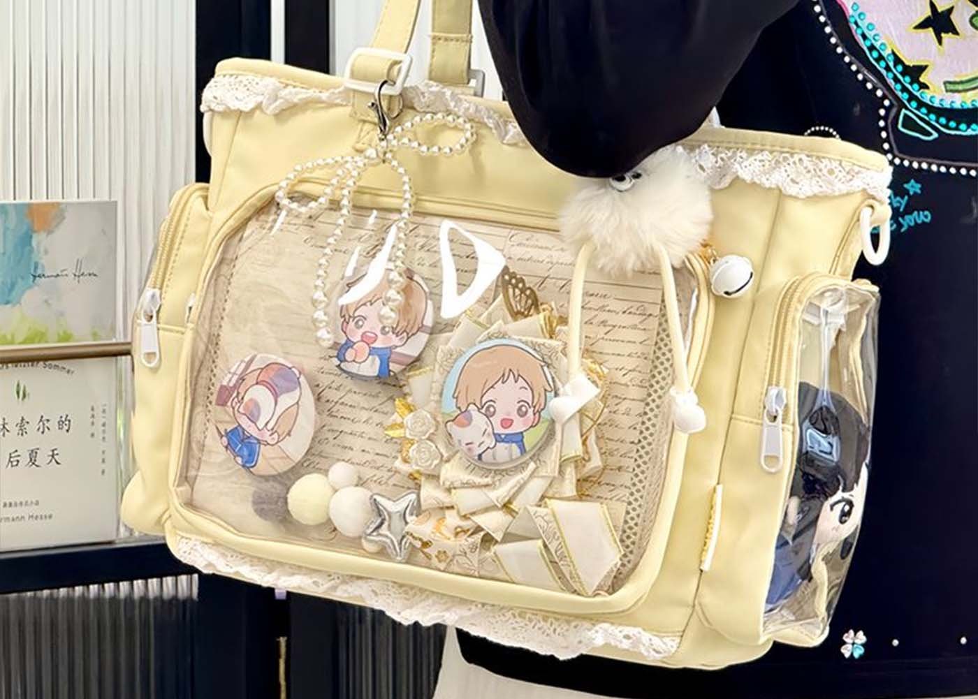 ita bag: what it is and 7 must-have customization ideas - laptop bag ita bag with clear window showing enamel pins, acrylic standees, and a pastel backing insert