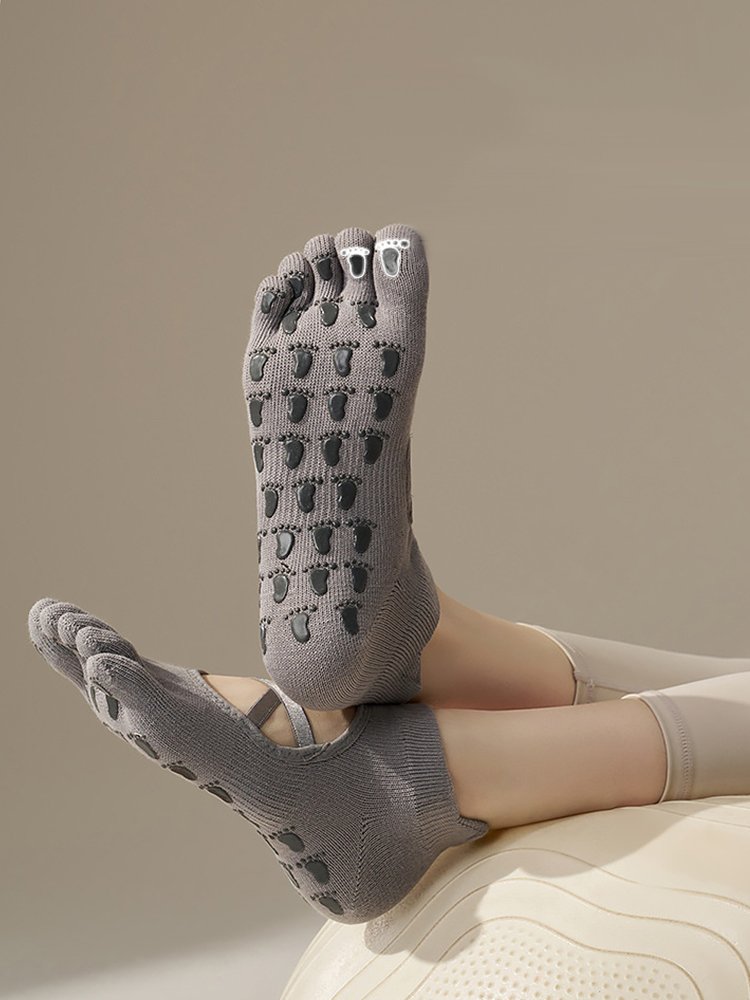 Sole of Cross Strap Pilates Socks showing footprint-shaped grips.
