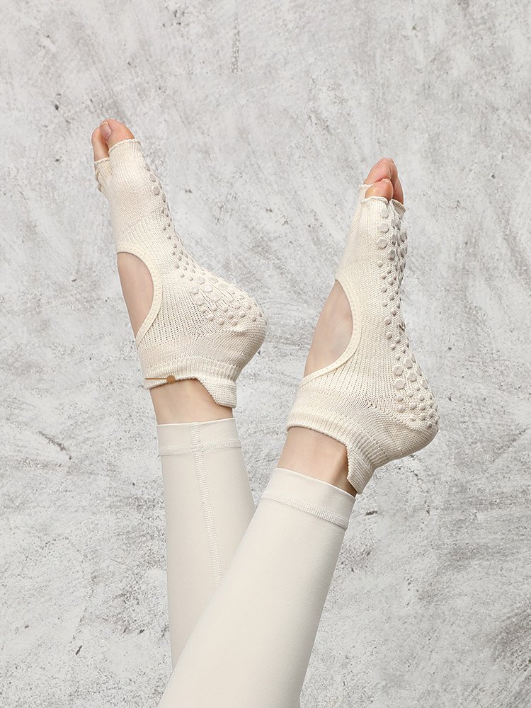 Model in a raised-leg pose wearing white Toeless Pilates Socks.