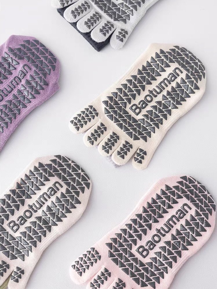 Flat lay of multiple Gradient Five-Toe Pilates Socks showing grip patterns.