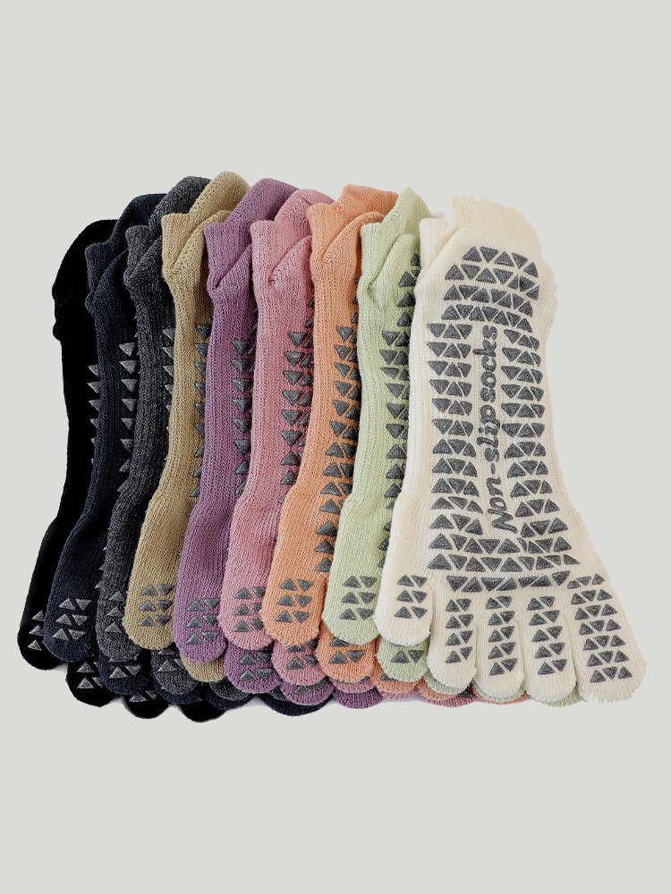 A collection of multi-colored five-toe grip socks, including pink, green, and beige.