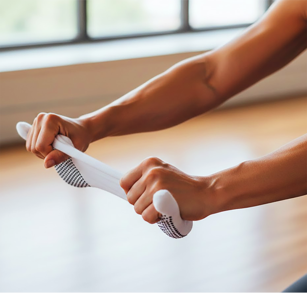 Manual tension testing of Professional Pilates Studio Gear to ensure durability.