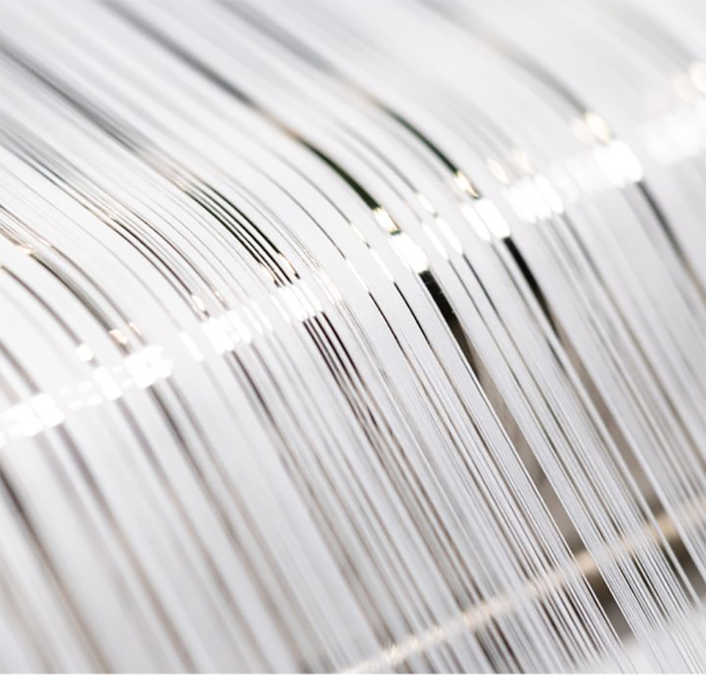 About Us - laptop bag Macro close-up of high-quality white combed cotton threads on a professional weaving loom.
